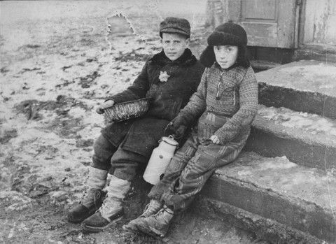 Two young boys with a milk can